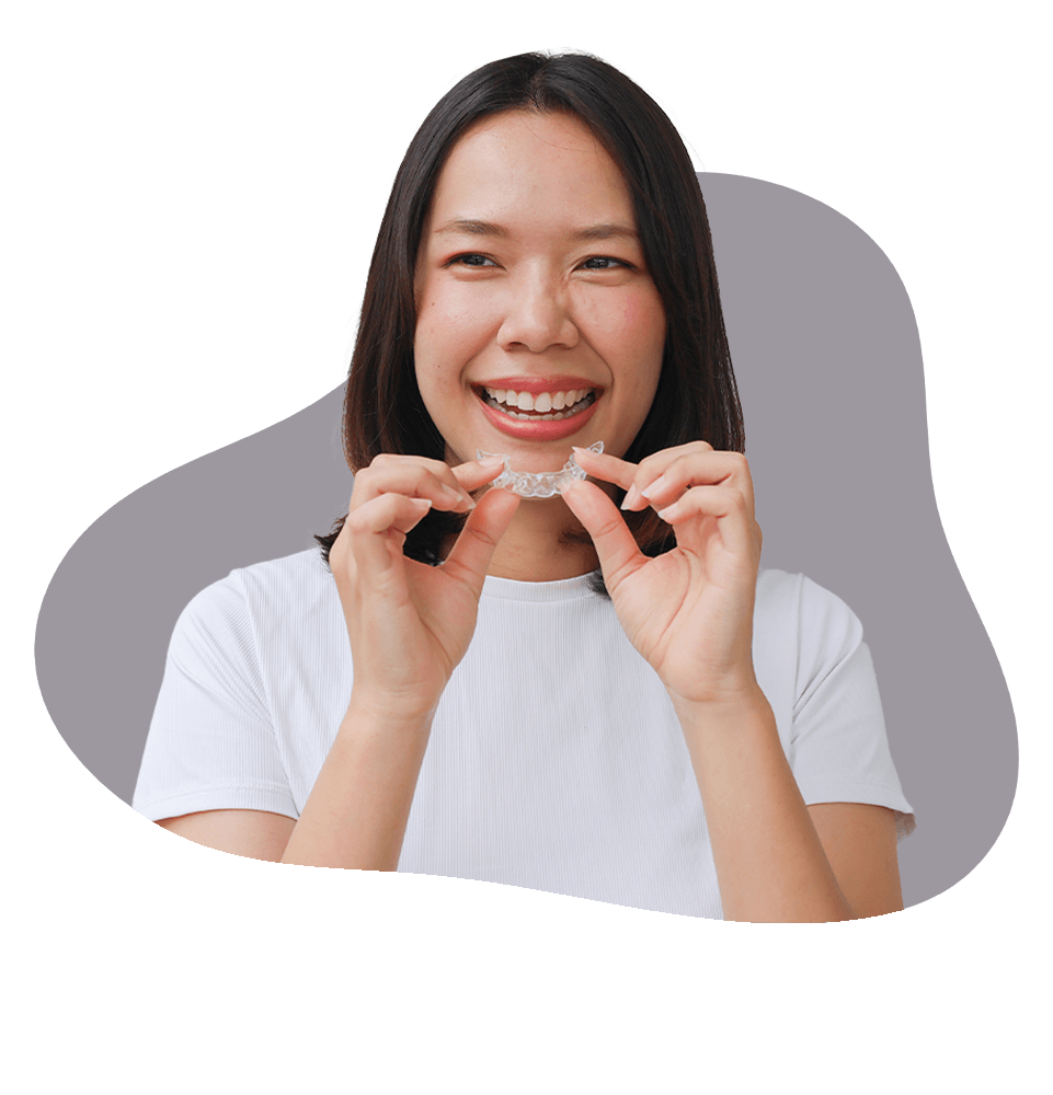 young person smiling while using their aligner