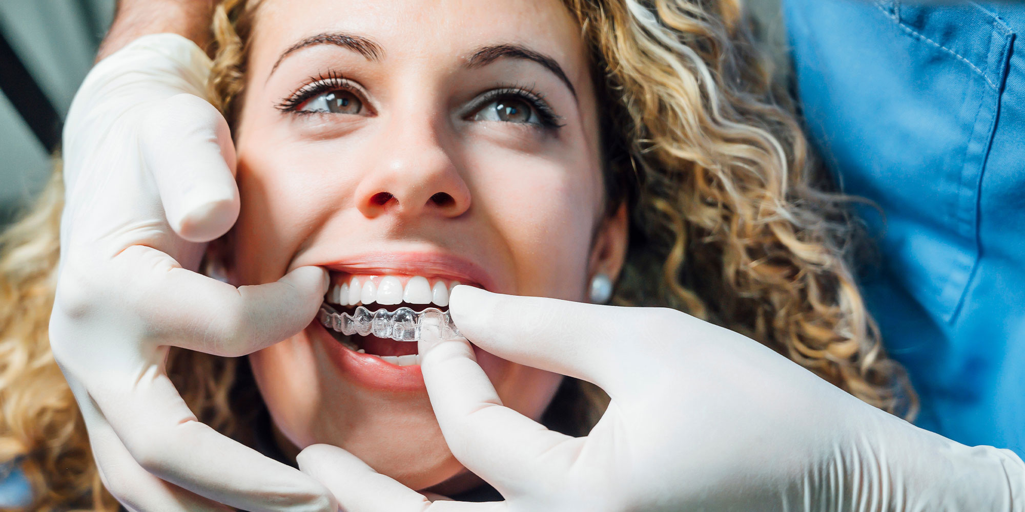 patient trying on their Invisalign within th dental center