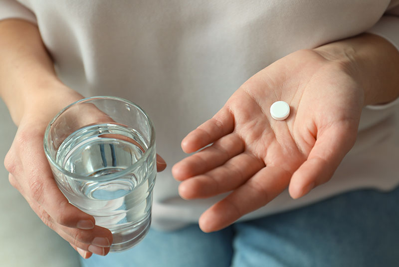 close up of patient taking oral sedation pill