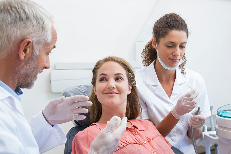 doctor going over dental treatment information with patient